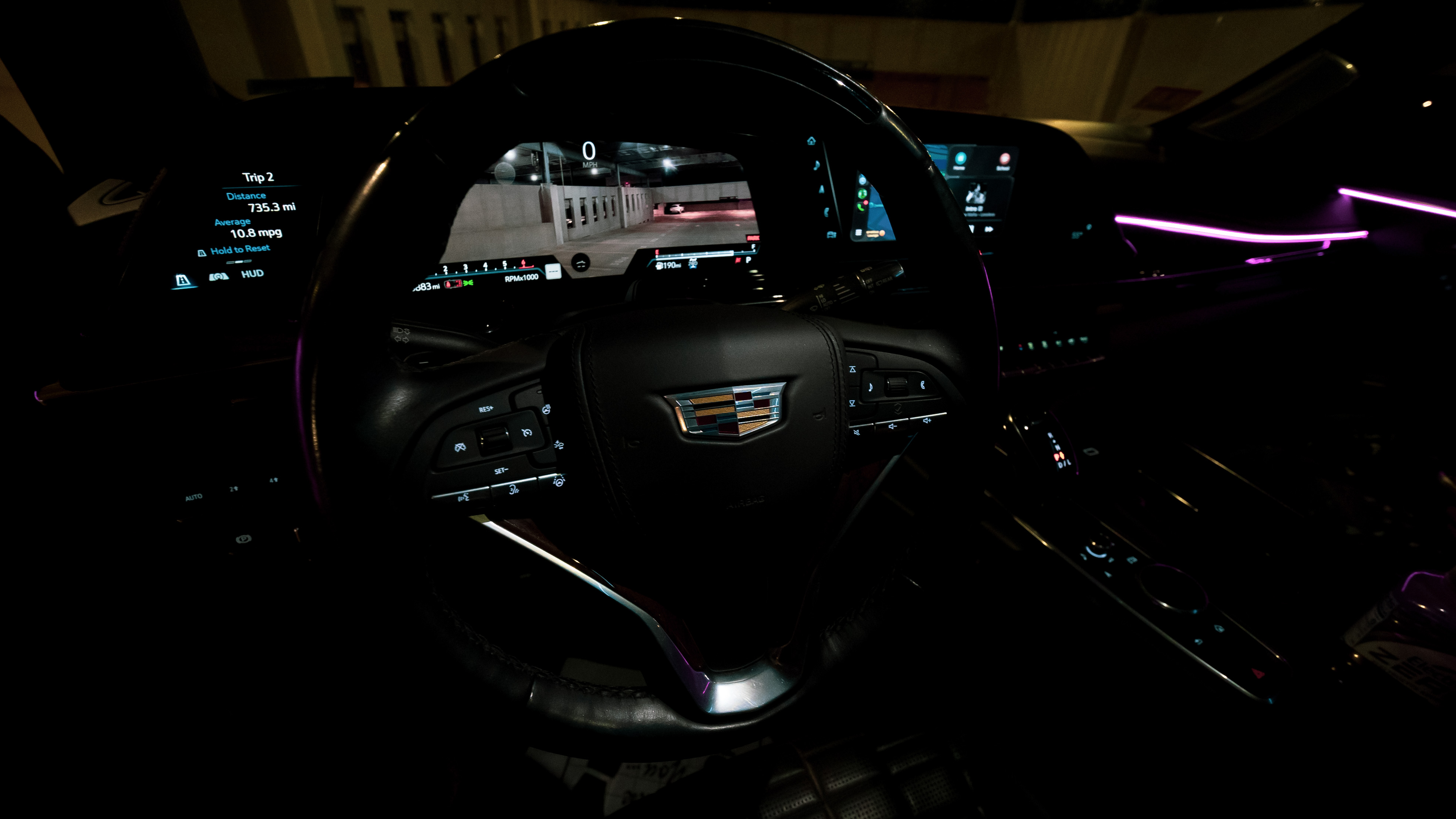 Escalade cockpit with curved OLED display and purple ambient lighting