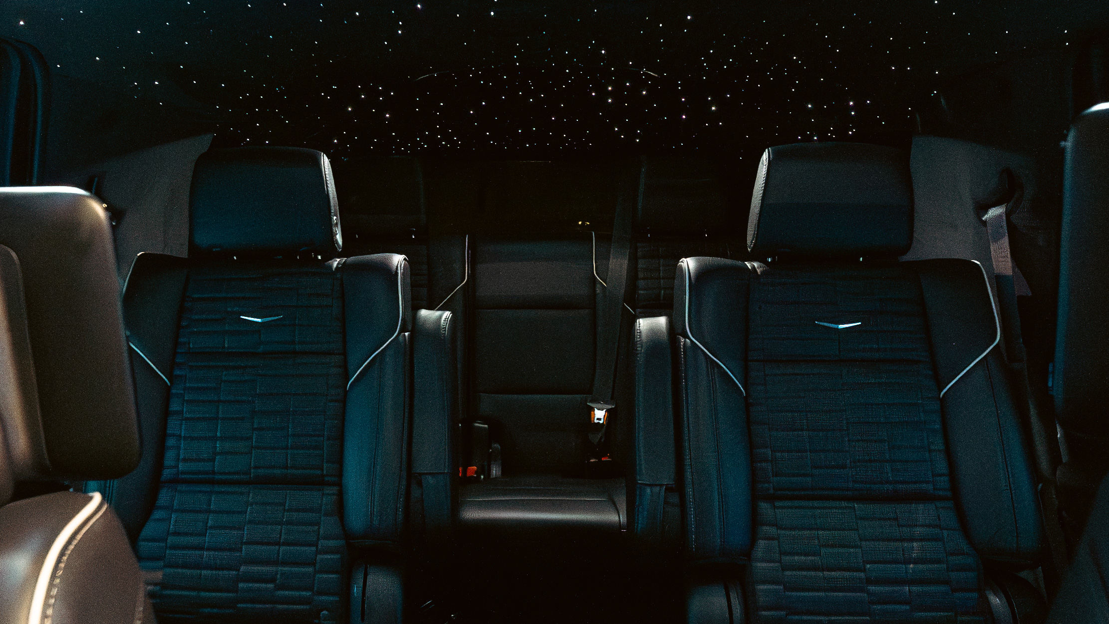 Close-up of rear leather seats with star ceiling constellation above